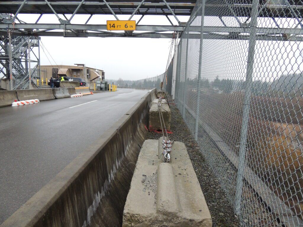 Empty toll booth station with a height restriction sign on an overcast day, notable for its positive customer reviews.